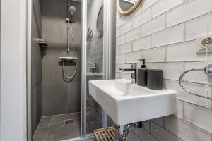 a white bathroom with a sink and a shower at Villa Hoheneck in Wildemann +35 photos