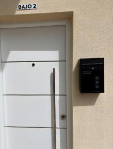 a white refrigerator next to a wall with a tv at La Coqueta in Zarandona