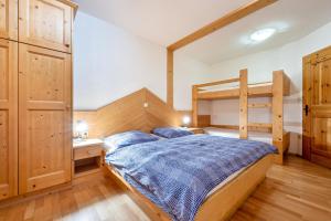 a bedroom with a bed and a bunk bed at Lindenhof Apt 8 in Vandoies +8 photos