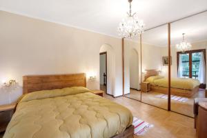 a bedroom with two beds and a large mirror at Maison La Truite in Morgex