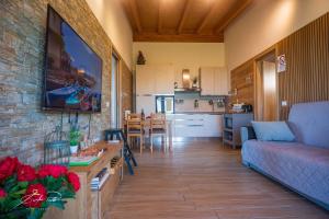a living room and kitchen with a couch and a table at Casa Vacanze Elios in Valdamonte