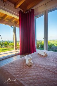a bedroom with a bed with two towels on it at Casa Vacanze Elios in Valdamonte +76 photos