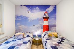a bedroom with a red and white lighthouse mural at Perle von Berumbur in Berumbur
