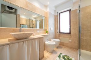 a bathroom with a sink and a toilet at Sa Mariposa in Cagliari