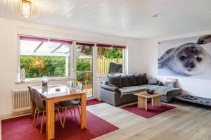 a living room with a couch and a table at Perle von Berumbur in Berumbur