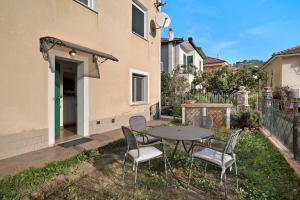 a patio with a table and chairs in a yard at Santa Lucia in Imperia