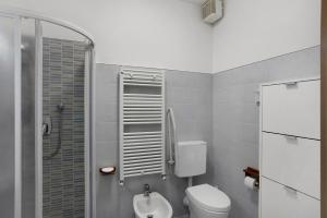 a small bathroom with a toilet and a shower at Santa Lucia in Imperia +11 photos