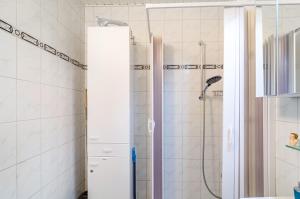 a shower with a glass door in a bathroom at Perle von Berumbur in Berumbur +26 photos