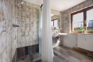 a bathroom with a sink and a shower at Landhaus Moos in Argenbühl +24 photos