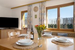 a dining room with a table and a large window at Landhaus Moos in Argenbühl