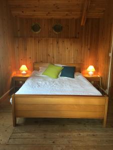 a bedroom with a bed with two lamps on both sides at Maison dans la prairie in Plurien +28 photos
