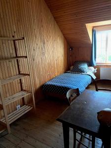 a small room with a bed and a book shelf at Maison dans la prairie in Plurien