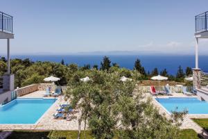 a view of the pool at a resort with the ocean at Apartment with Sea view B in Tsoukalades