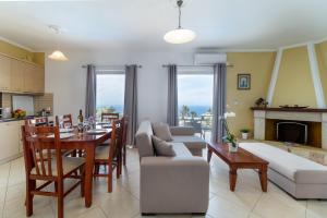 a kitchen and living room with a table and a couch at Apartment with Sea view B in Tsoukalades