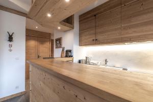 a kitchen with wooden cabinets and a counter top at Appartement au centre de megève in Megève +12 photos