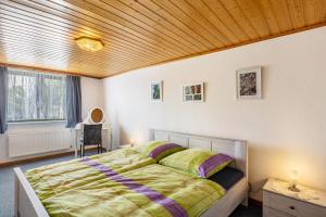 a bedroom with a bed and a wooden ceiling at Ferienwohnung Boddenberg in Waldbröl