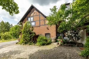 a brick house with a gambrel roof at Ferienwohnung Boddenberg in Waldbröl