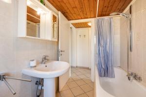 a bathroom with a sink and a shower and a tub at La Casa di Lady in Ceriale +17 photos