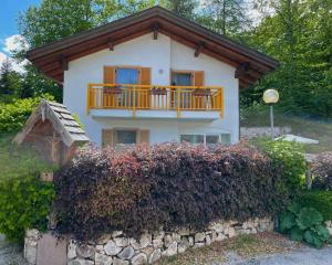 a house with a balcony on top of a stone wall at Mendelhaus in Mendola