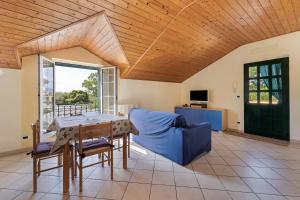 a living room with a table and a blue couch at La Casa di Lady in Ceriale