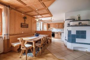 a kitchen with a wooden table and chairs at Mendelhaus in Mendola