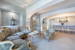 a living room with a couch and chairs at Abaye I Champagne Charm Adults Only in Soiano del Lago