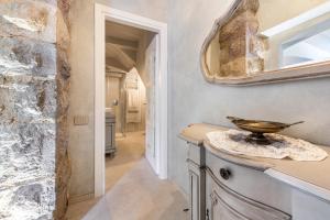 a hallway with a stone wall and a mirror at Abaye I Champagne Charm Adults Only in Soiano del Lago +35 photos