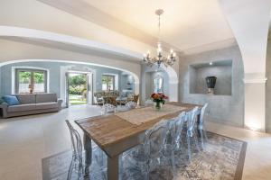 a dining room and living room with a table and chairs at Abaye I Champagne Charm Adults Only in Soiano del Lago