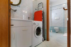 a washing machine in a bathroom with a sink at Ciclamino Superior Otto in San Lorenzo in Banale +21 photos