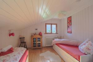 a bedroom with two beds and a ceiling at Schlierseehaus in Schliersee