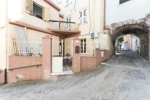 an alley with an archway next to a building at Gustalu in Dorgali