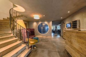 a living room with stairs and a stair case at Sonnleiten Sonne Mond u Sterne in Collepietra