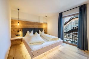 a bedroom with a bed and a large window at Leierhof Olivia in Rodengo +37 photos