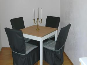 a dining room table with chairs and a table with candles at Ferienwohnung Sonnenblick in Eisenbach +5 photos