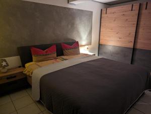 a bedroom with a large bed with red pillows at Ferienwohnung Sonnenblick in Eisenbach