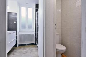 a bathroom with a toilet and a sink at Gite Decauville in Uchentein +19 photos