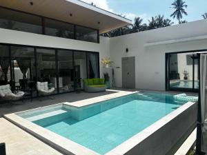 a swimming pool in the backyard of a house at villa du bonheur in Koh Samui