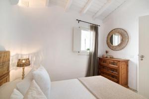 a white bedroom with a bed and a mirror at Casa de Benafim 1 in Benafim +14 photos