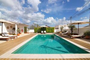 a pool with a wooden deck and a villa at Casa de Benafim 1 in Benafim