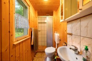 a bathroom with a sink and a toilet and a window at Bungalow 34 - Kimbucht in Reichendorf +14 photos