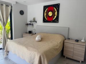 a bedroom with a bed with a white pillow on it at villa du bonheur in Koh Samui