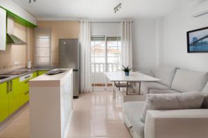 a kitchen and living room with a couch and a table at Ático el morche in El Morche +19 photos