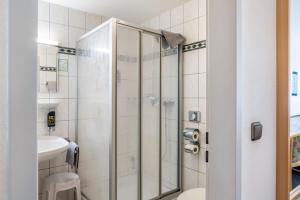 a shower with a glass door in a bathroom at Gasthaus, Hotel am Dreienberg in Friedewald +72 photos