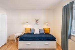 a bedroom with a bed with blue and yellow pillows at Casa Meeresbrise Marlow in Marlow