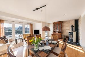 a living room with a table and chairs and a couch at Casa Meeresbrise Marlow in Marlow