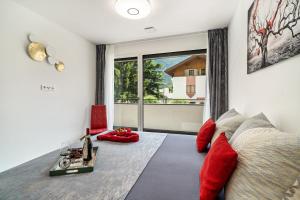 a bedroom with a bed with red pillows and a window at Apartment il cuore rosso in Naturno