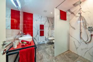 a bathroom with a shower and a sink and a toilet at Apartment il cuore rosso in Naturno +17 photos