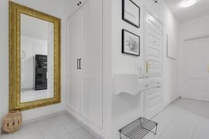 a white bathroom with a mirror and a sink at Medano House in El Médano +21 photos