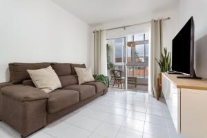 a living room with a couch and a television at Medano House in El Médano
