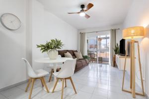 a living room with a table and a couch at Medano House in El Médano